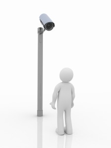 Photo credit: Security camera and man on white background // ShutterStock
