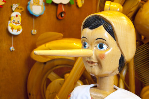 [image credit: Gigra / Shutterstock -- "wooden Pinnochio doll with long nose"]