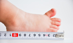 Photo credit: "measuring baby feet" // ShutterStock